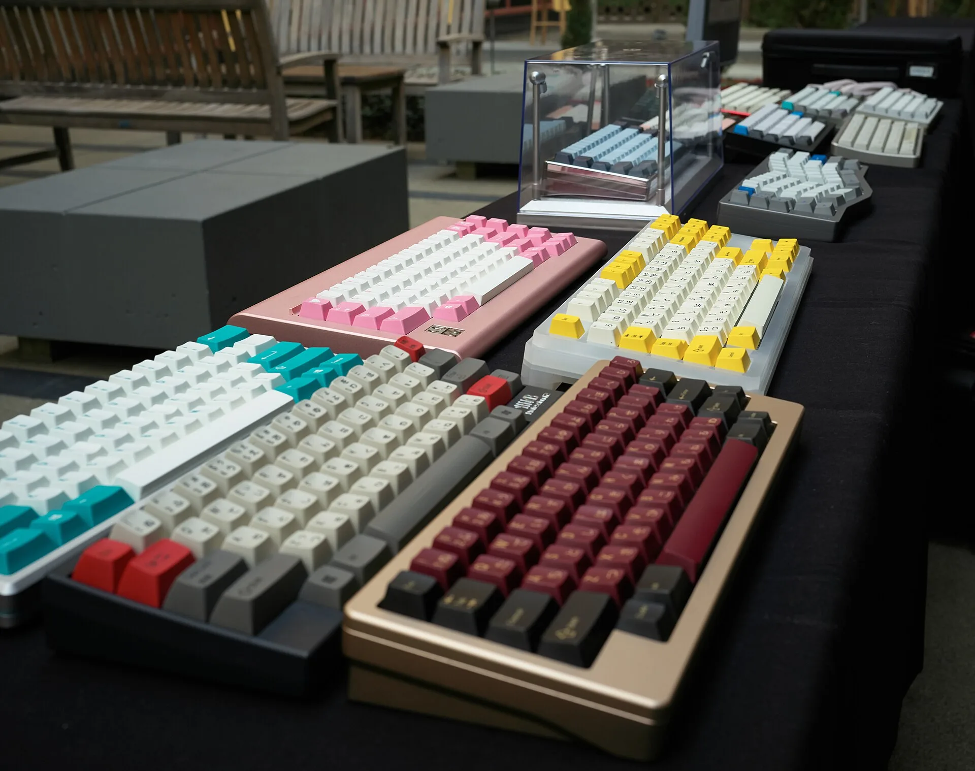 A table of custom mechanical keyboards at a community meetup
